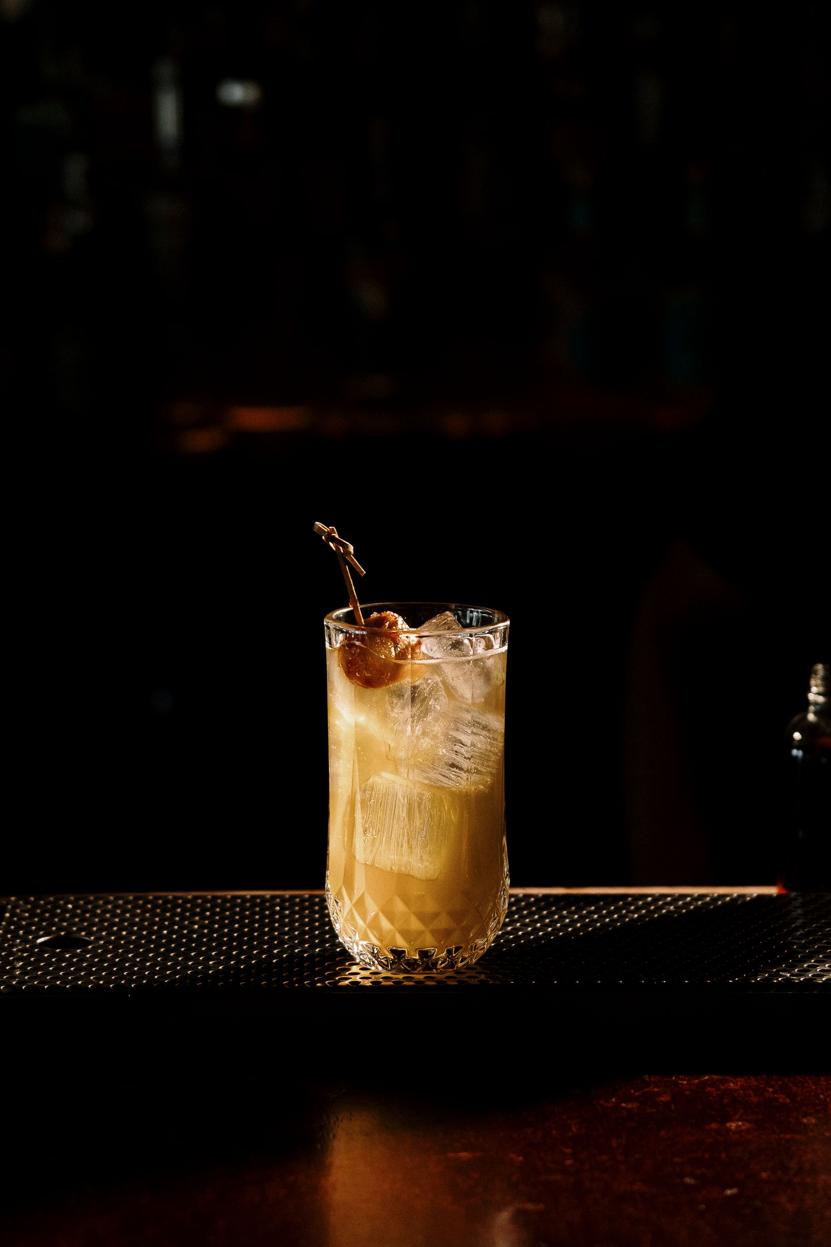 Chilled cocktail on a dark bar counter