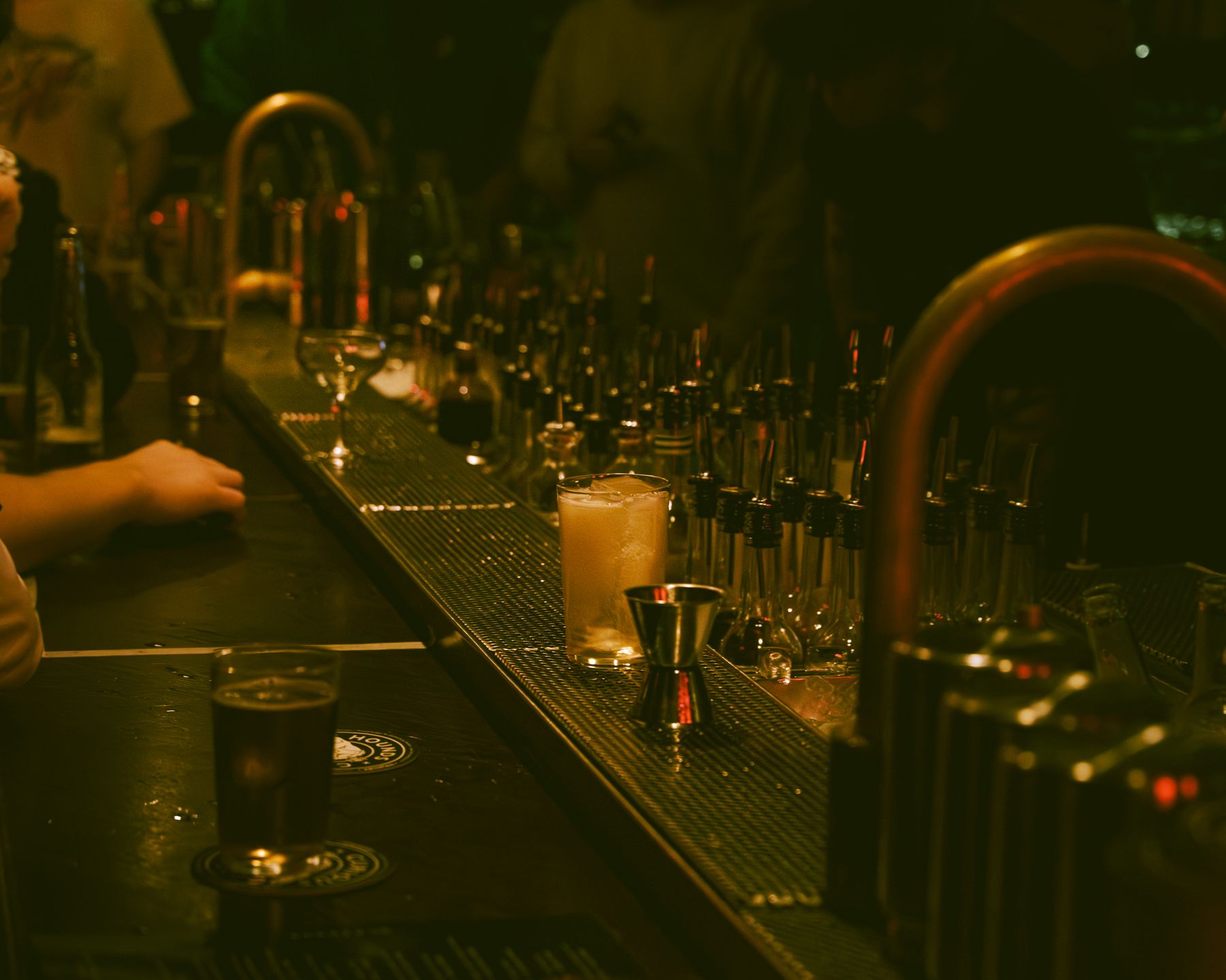 Moody bar at night with glasses and taps